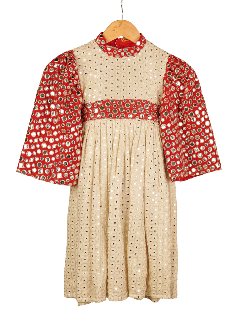 Beige dress with red patterned sleeves and collar on a white background