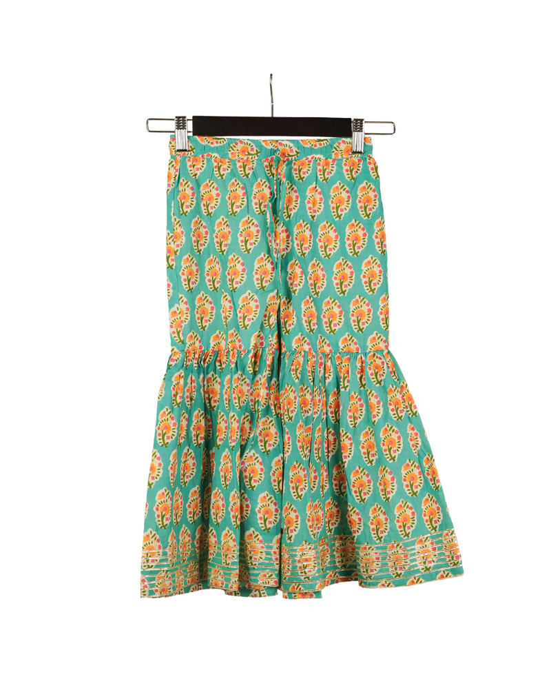 Green skirt with orange floral pattern on a hanger against a white background