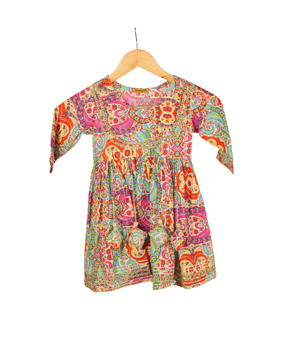 Colorful patterned dress on a hanger against a white background