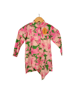 Floral patterned shirt on a hanger with a white background