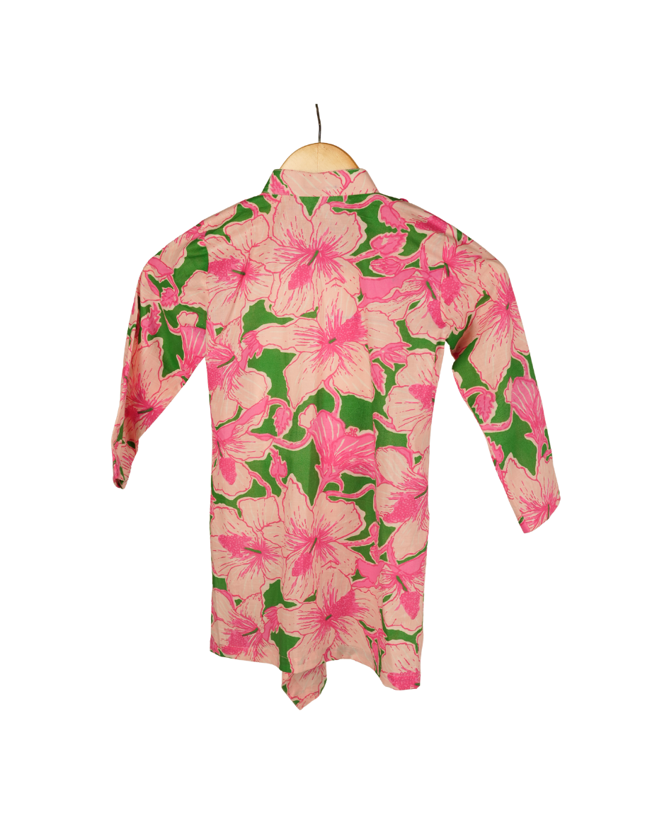 Floral patterned shirt on a hanger against a white background