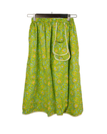 Green patterned skirt with a white background