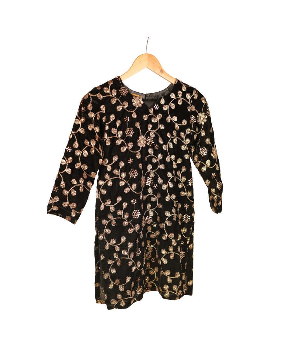 Black dress with gold floral pattern on a hanger against a white background