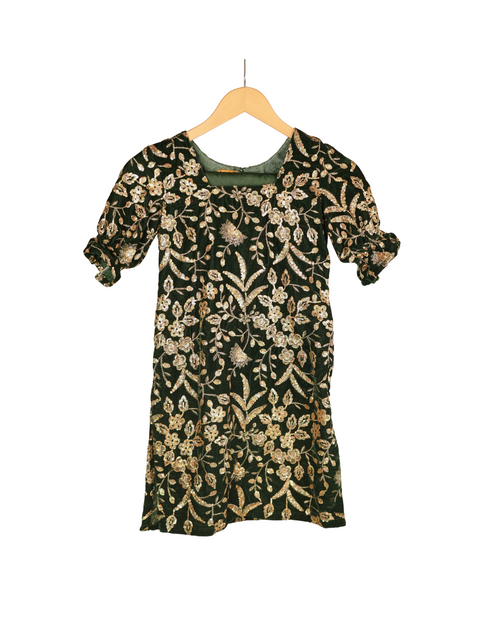 Floral patterned dress on a wooden hanger against a white background
