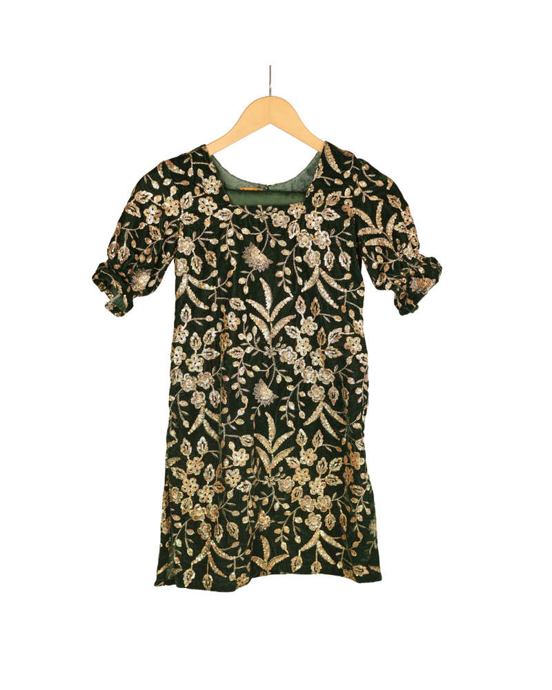 Floral patterned dress on a wooden hanger against a white background