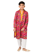 Child wearing a colorful floral kurta with white pants on a white background