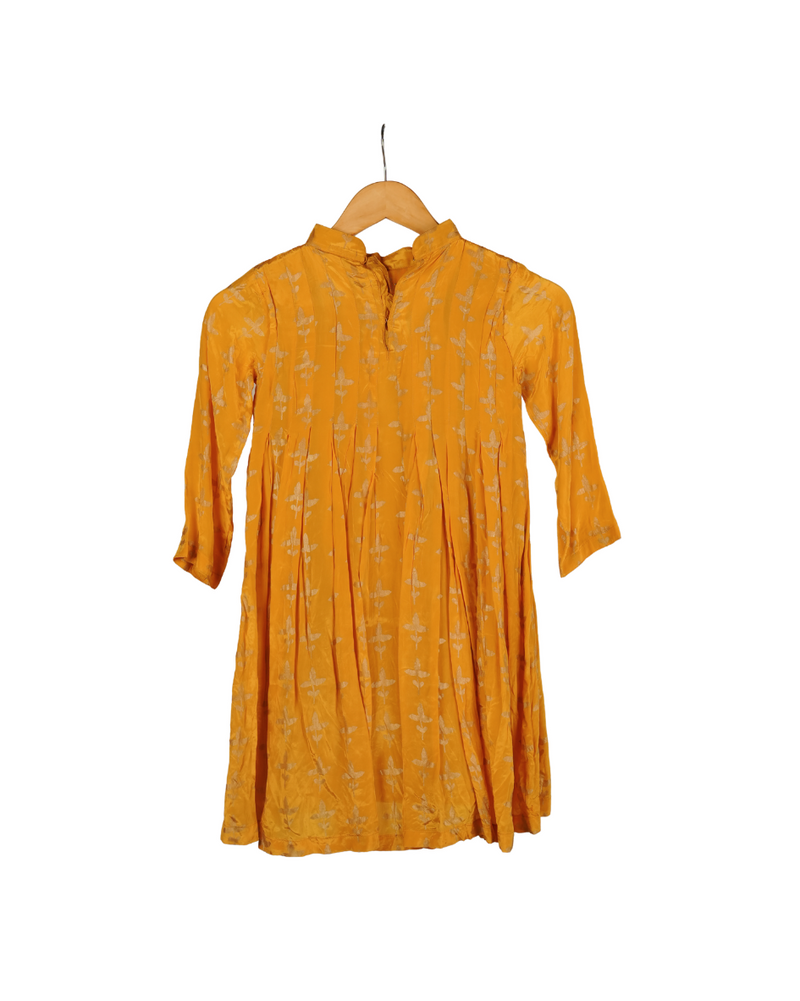 Yellow dress on a hanger against a white background