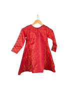 Red dress with floral pattern on a hanger against a white background