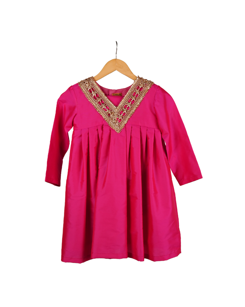 Pink dress with gold embroidery on a hanger against a white background