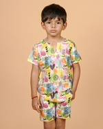 Child wearing a colorful patterned outfit on a beige background