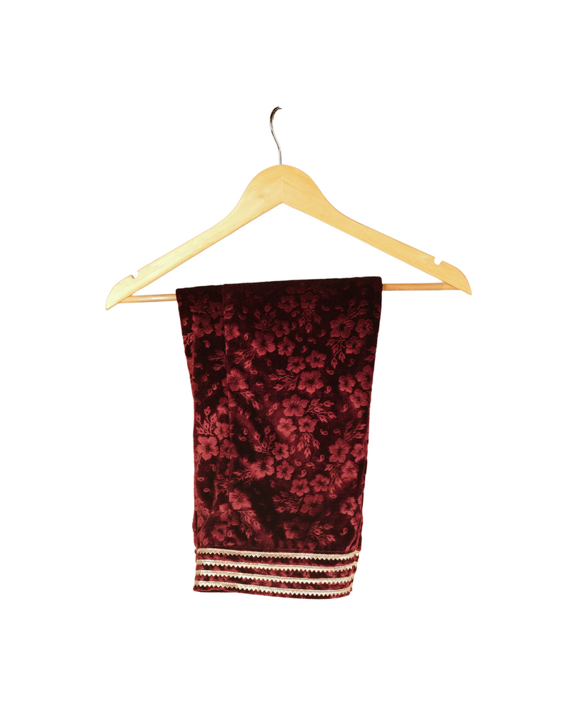 Red patterned scarf on a wooden hanger against a white background
