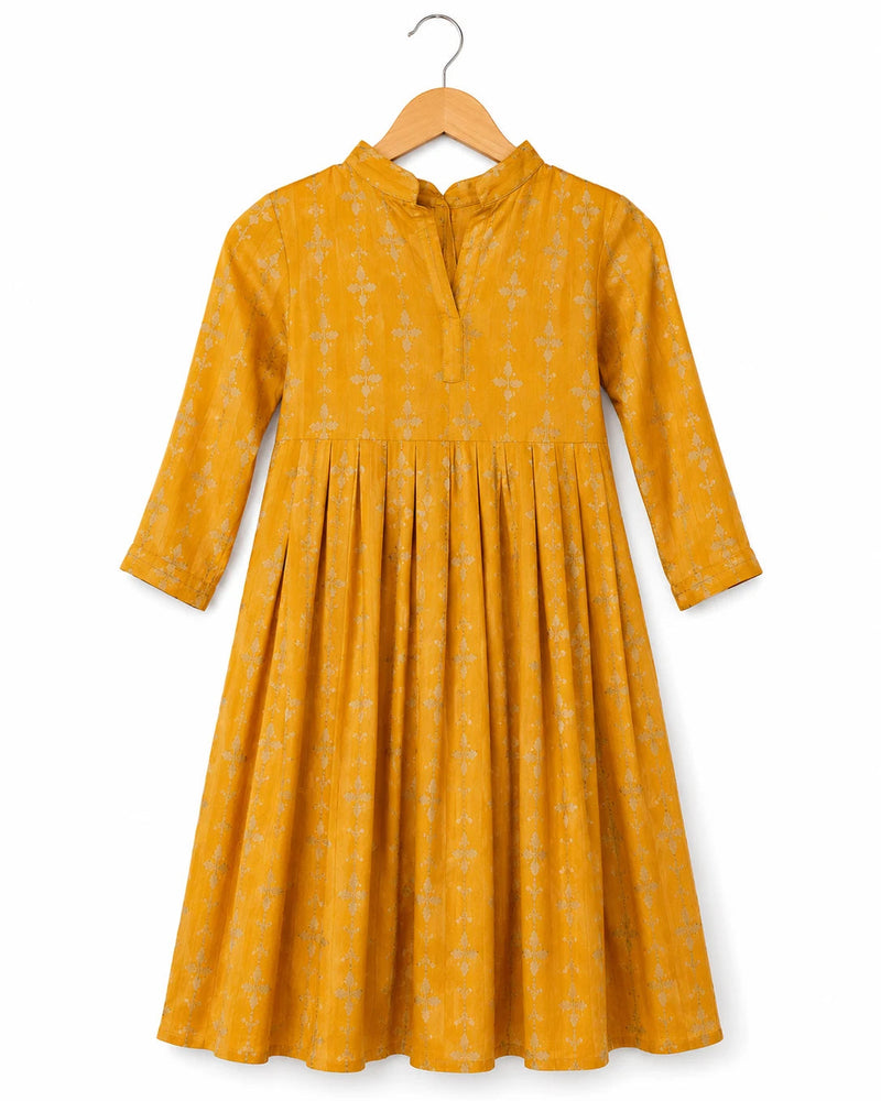 Yellow dress with floral pattern on a hanger against a white background