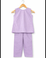Purple sleeveless top and pants set on a hanger against a white background