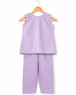 Purple sleeveless top and pants set on a hanger against a white background