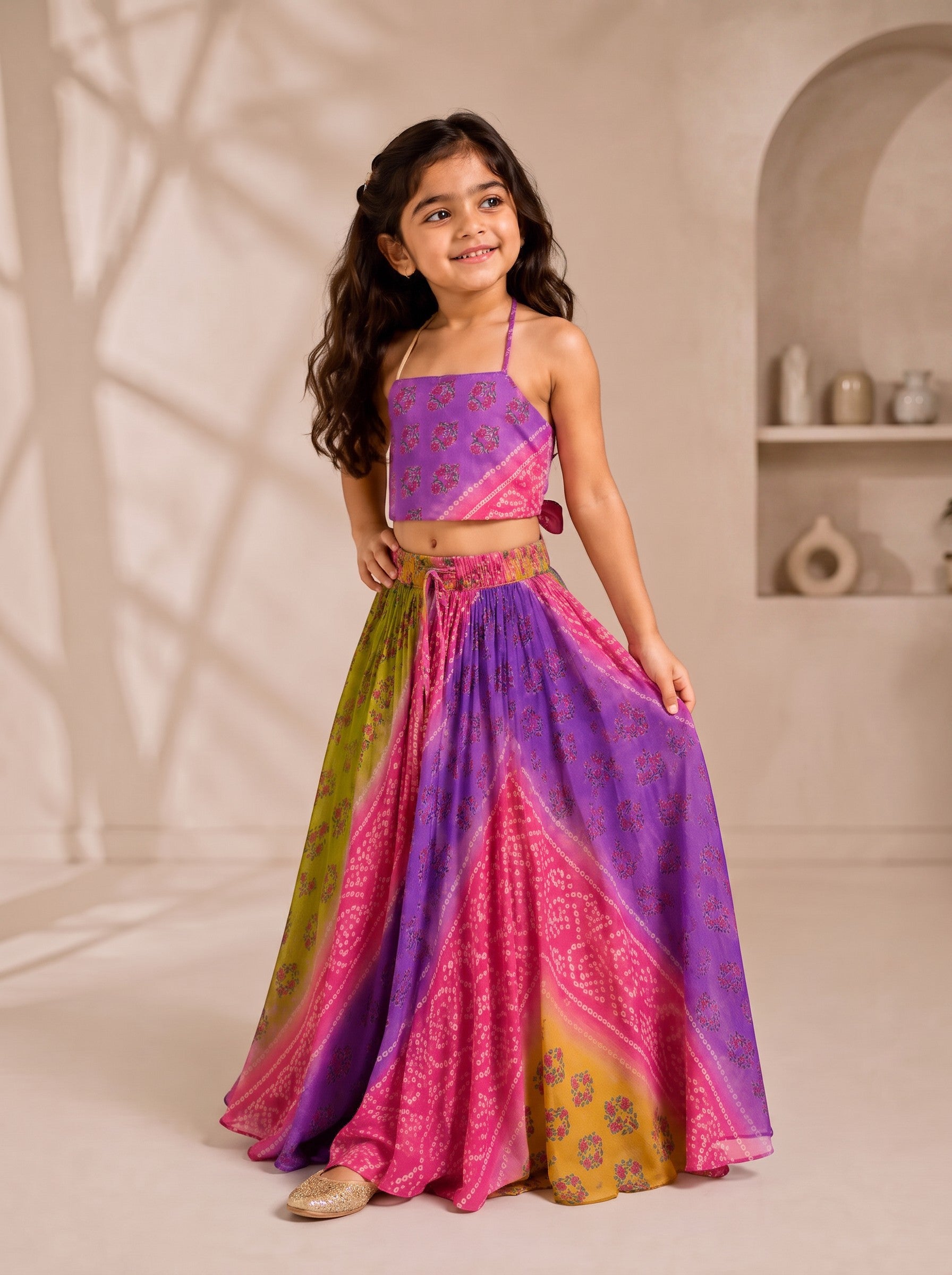 Ameyru Kids Wear girl wearing a vibrant purple, pink, and lime green floral ethnic crop top and flowing skirt set.