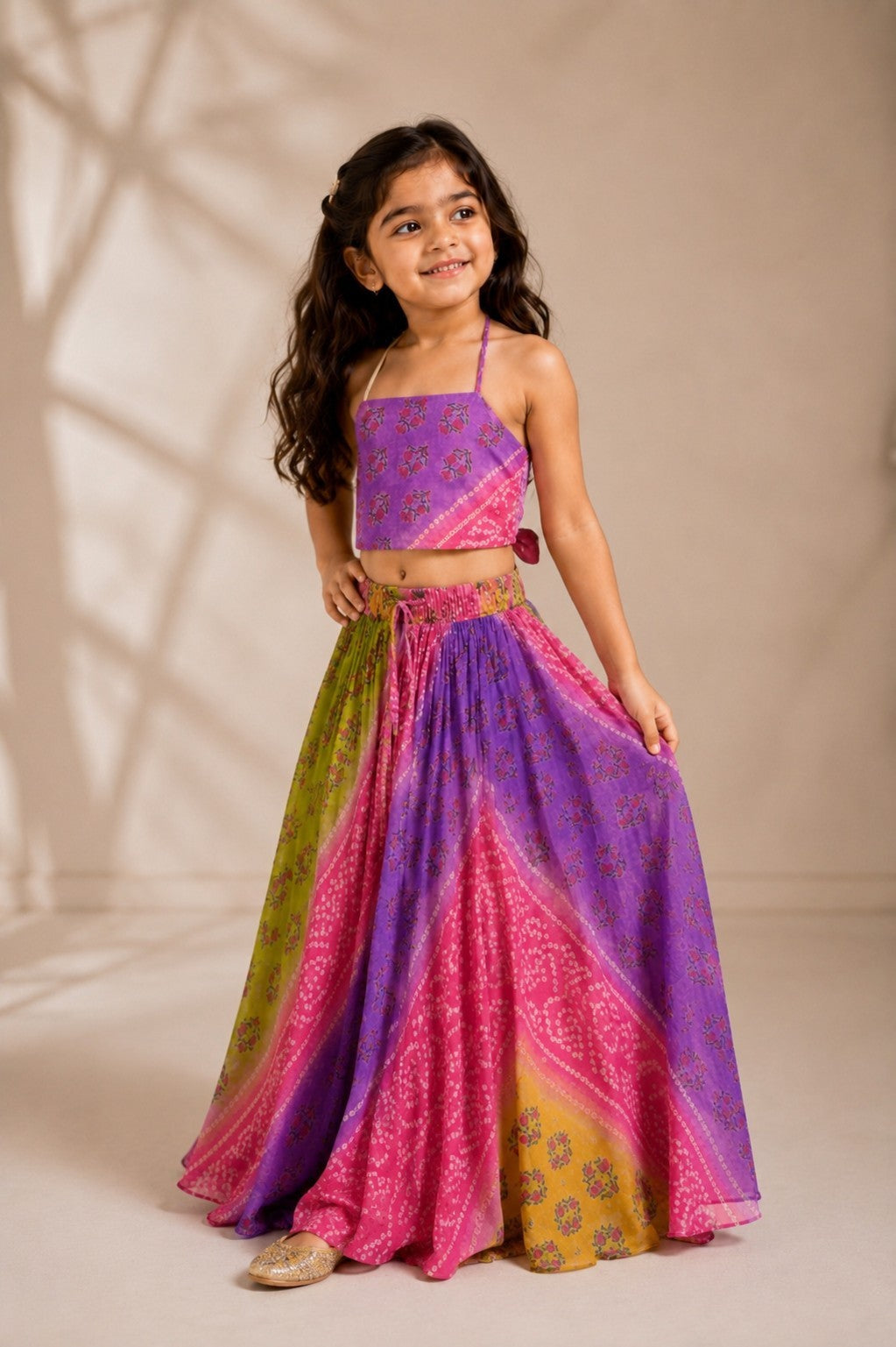 Ameyru Kids Wear girl wearing a vibrant purple, pink, and green floral print lehenga set with a matching crop top