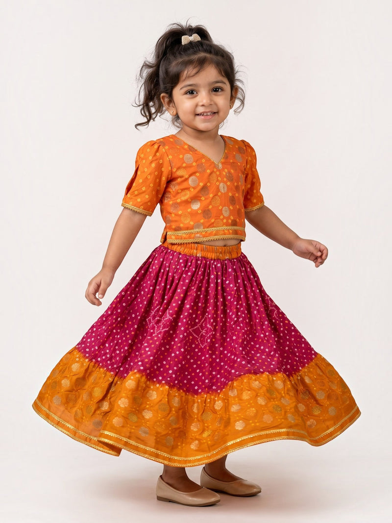 Ameyru Kids Wear orange and magenta lehenga choli with bandhani print and gold foil motifs for girls