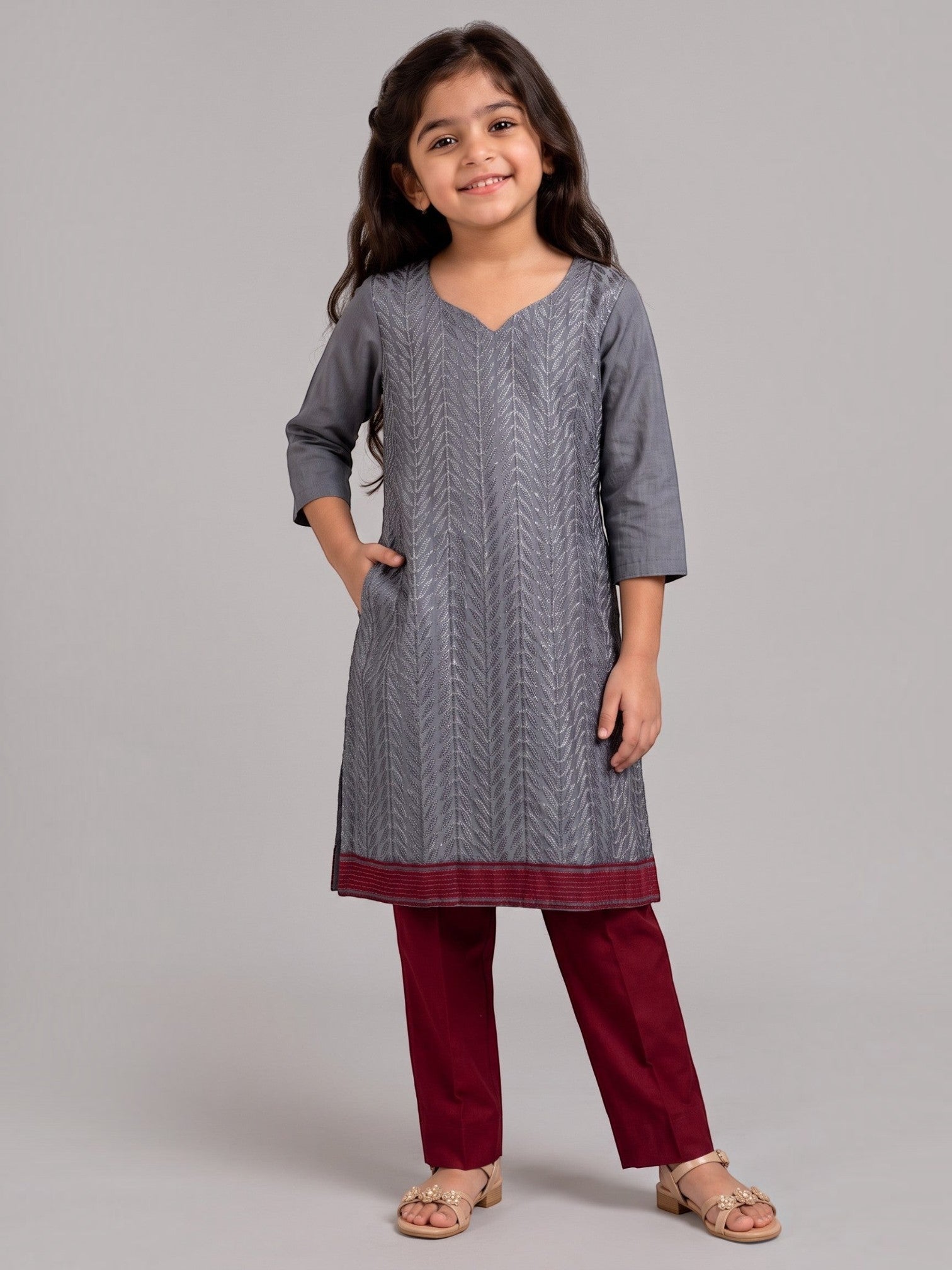 Ameyru Kids Wear grey chevron kurta with maroon border and trousers worn by a smiling girl in a studio setting