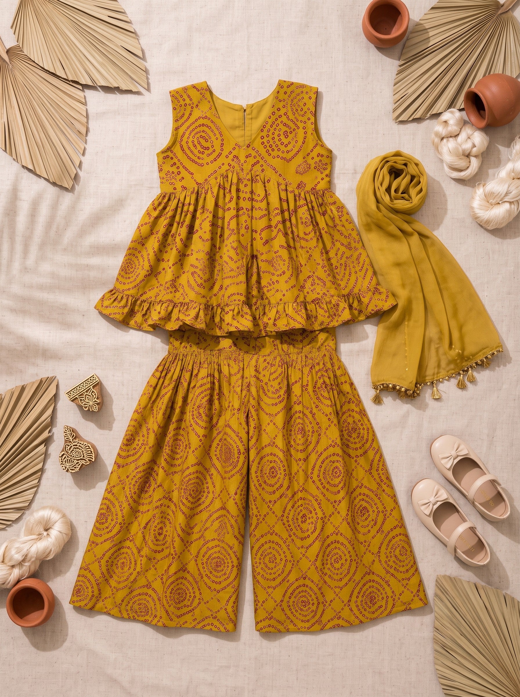 Ameyru Kids Wear mustard yellow bandhani print peplum top and sharara set with matching dupatta for girls.