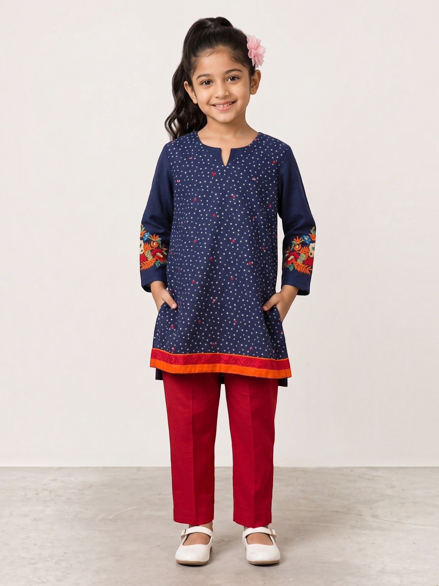 Ameyru Kids Wear navy blue polka dot kurta with floral embroidery and red trousers worn by a young girl
