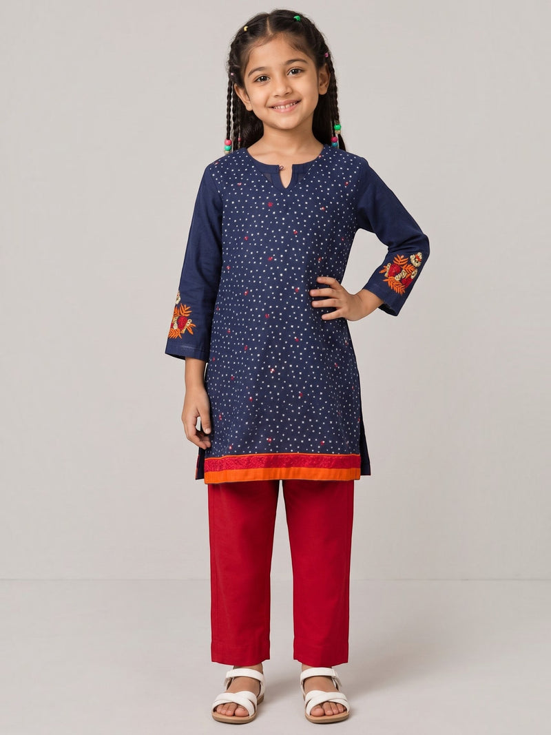 Ameyru Kids Wear navy blue polka dot kurta with floral embroidery and red trousers worn by a smiling young girl