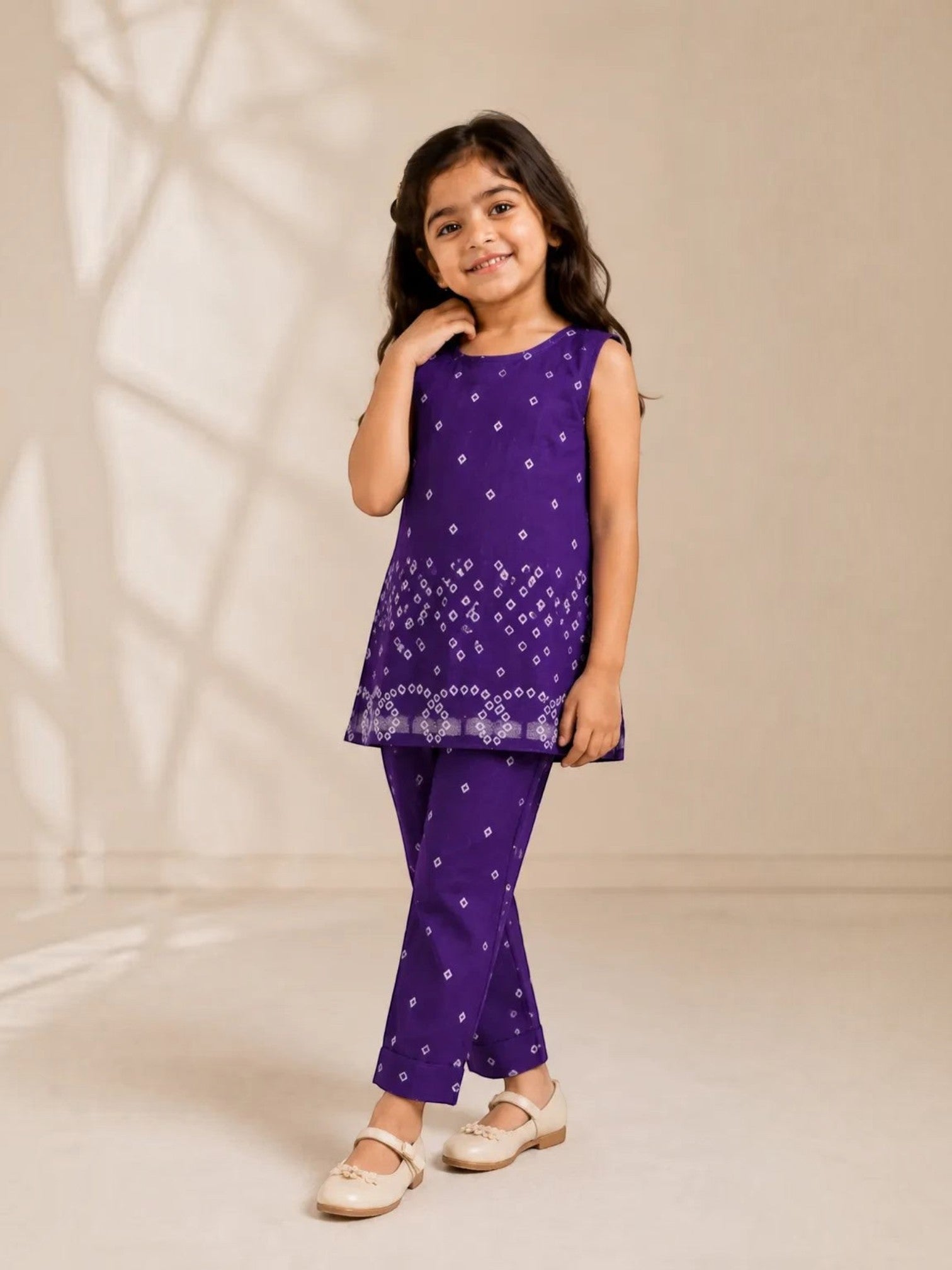 Ameyru Kids Wear purple sleeveless kurta and pant set with white geometric print worn by a smiling young girl