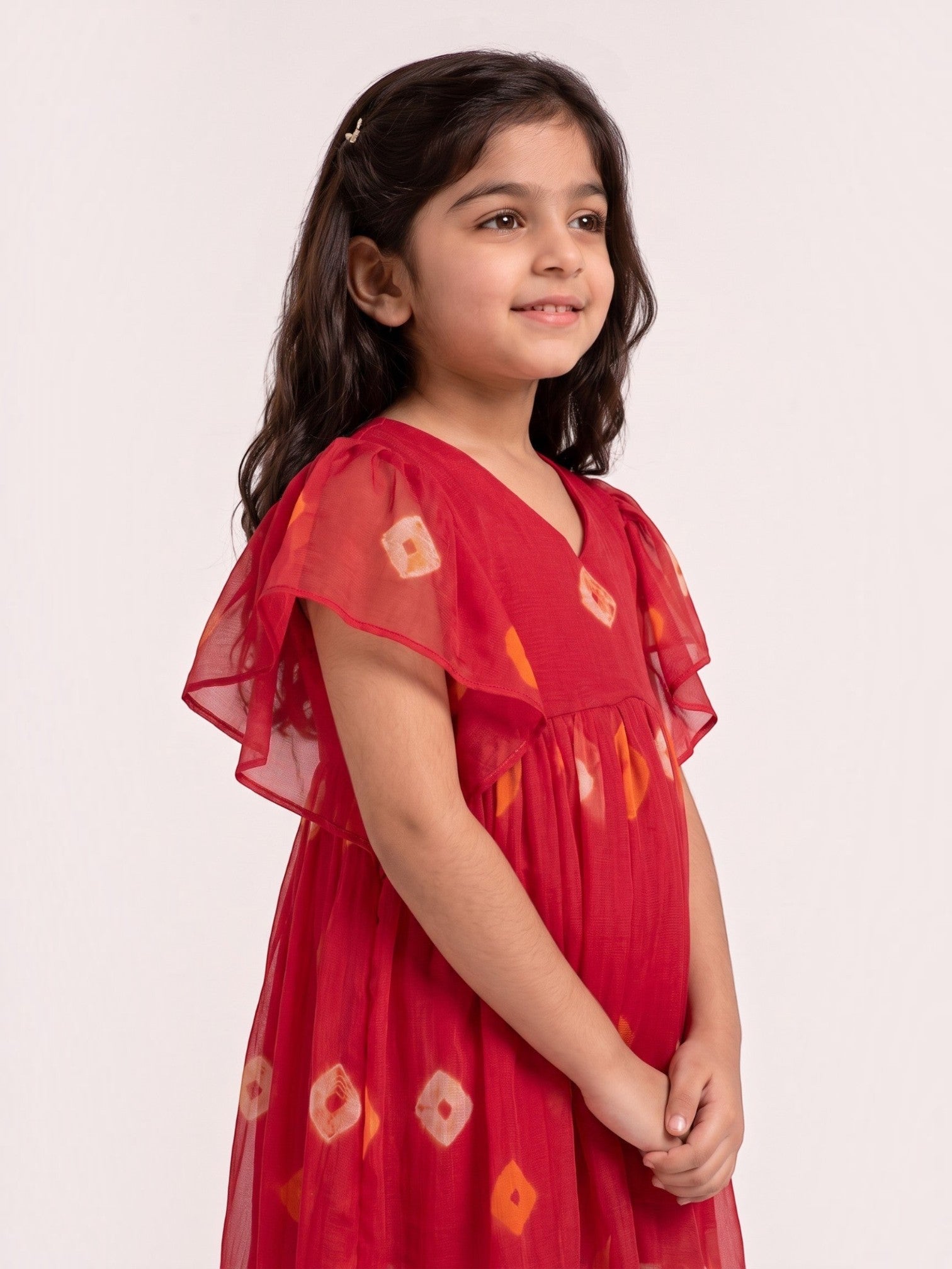 Ameyru Kids Wear red flutter sleeve dress with diamond print on a young girl, featuring a V-neck and gathered waist.