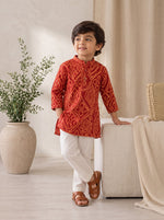 Ameyru Kids Wear red ethnic kurta with traditional patterns paired with white trousers on a young boy