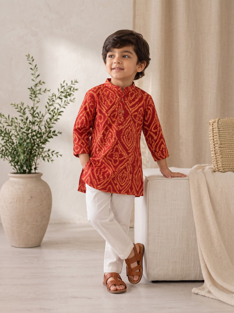 Ameyru Kids Wear red ethnic kurta with traditional patterns paired with white trousers on a young boy