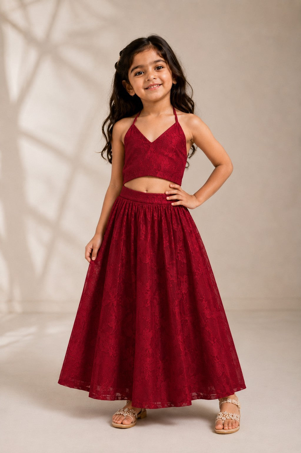 Ameyru Kids Wear girl in a deep red lace crop top and matching long skirt lehenga set for festive occasions.