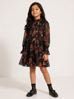 Baby Kids Cloths girl wearing a black floral print long sleeve mini dress with a ruffled hem and high neckline.