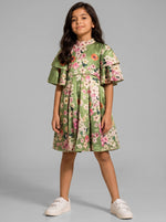 Young girl wearing a Baby Kids Cloths green satin dress with a floral print, ruffled sleeves, and a high neckline.