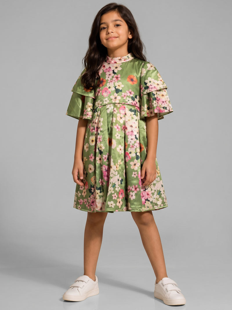 Young girl wearing a Baby Kids Cloths green satin dress with a floral print, ruffled sleeves, and a high neckline.
