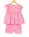 A pink cotton co-ord set for girls, with a ruffle sleeve top and matching shorts, displayed on a hanger.