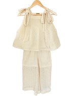 A beige cotton net fabric kids' co-ord set, consisting of a tunic top and trousers, displayed on a hanger.